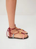 Nöista A Unique Flat Sandal Featuring Multicolored Rope Straps With A Wrap-Around Lace-Up Design For A Bold And Playful Look.